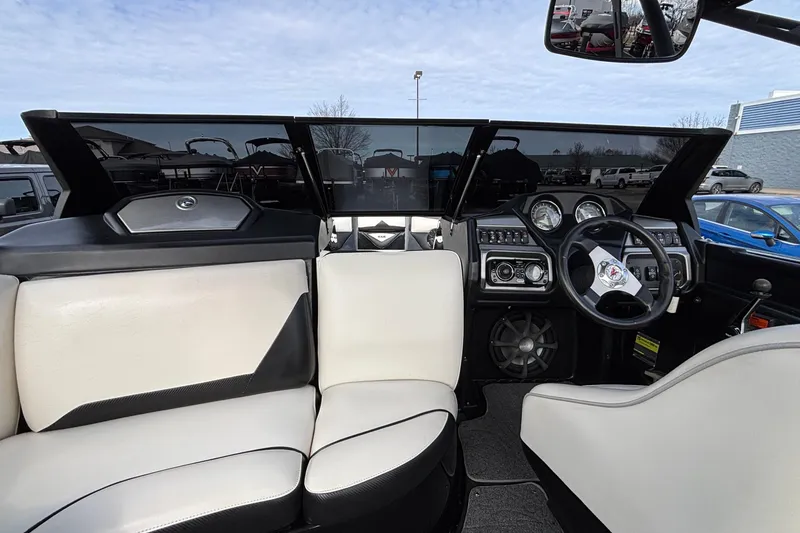 Slide: The Image of Interior of a 2012 Axis A22 boat featuring steering wheel and dashboard controls. - 32