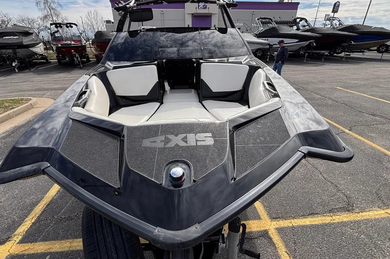 Slide: The Image of 2012 Axis A22 boat with sleek black design and spacious seating, displayed outdoors. - 40