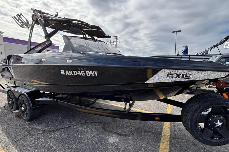 Slide: The Image of 2012 Axis A22 boat on trailer in parking lot under cloudy sky. - 41