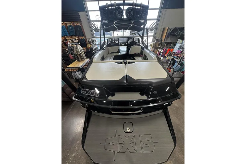 Slide: The Image of 2012 Axis A22 boat displayed indoors, featuring sleek black and white design. - 44