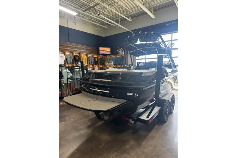 Slide: The Image of 2012 Axis A22 boat on trailer in showroom with apparel display. - 45