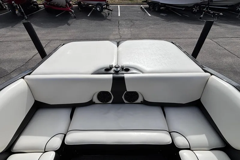 Slide: The Image of 2012 Axis A22 boat interior with white cushioned seating and speaker system. - 5