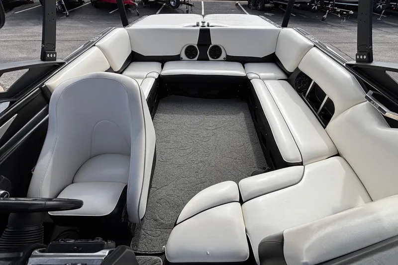 Slide: The Image of Interior of a 2012 Axis A22 boat with white seating and carpeted floor. - 7