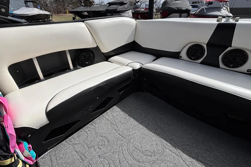 Slide: The Image of Interior of a 2012 Axis A22 boat with white and black seating and speakers. - 8