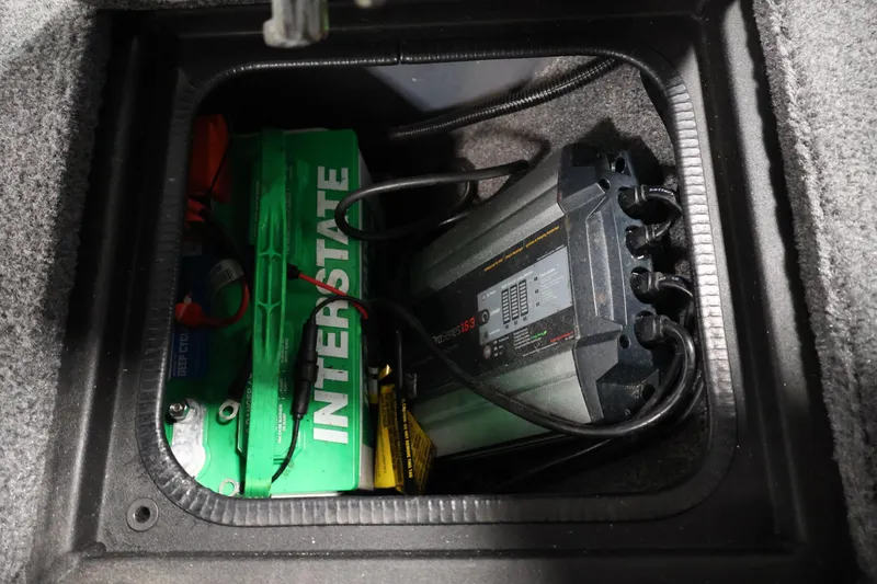 Slide: The Image of Battery compartment of 2024 Tracker Pro Guide V-16 WT with Interstate battery and charger. - 15