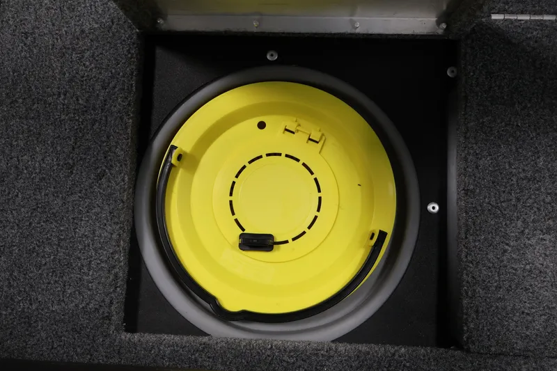 Slide: The Image of 2024 Tracker Pro Guide V-16 WT boat storage compartment with yellow circular hatch. - 19