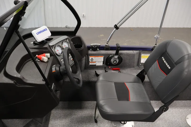 Slide: The Image of 2024 Tracker Pro Guide V-16 WT boat interior with steering wheel and seating. - 20