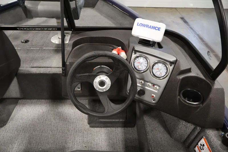 Slide: The Image of 2024 Tracker Pro Guide V-16 WT boat dashboard with steering wheel and Lowrance display. - 21