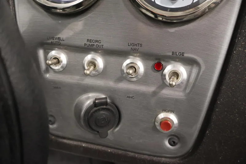 Slide: The Image of 2024 Tracker Pro Guide V-16 WT dashboard with switches for livewell, lights, bilge, and horn. - 26