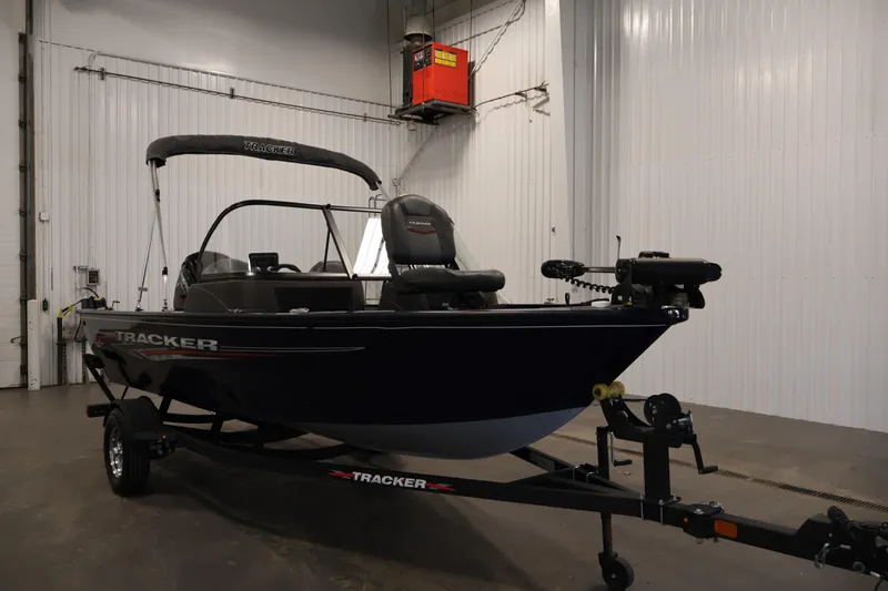 Slide: The Image of 2024 Tracker Pro Guide V-16 WT boat in a garage setting. - 3