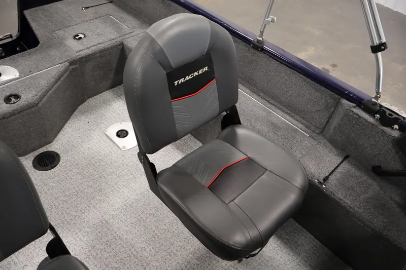 Slide: The Image of 2024 Tracker Pro Guide V-16 WT boat interior with gray seating and carpeted flooring. - 32