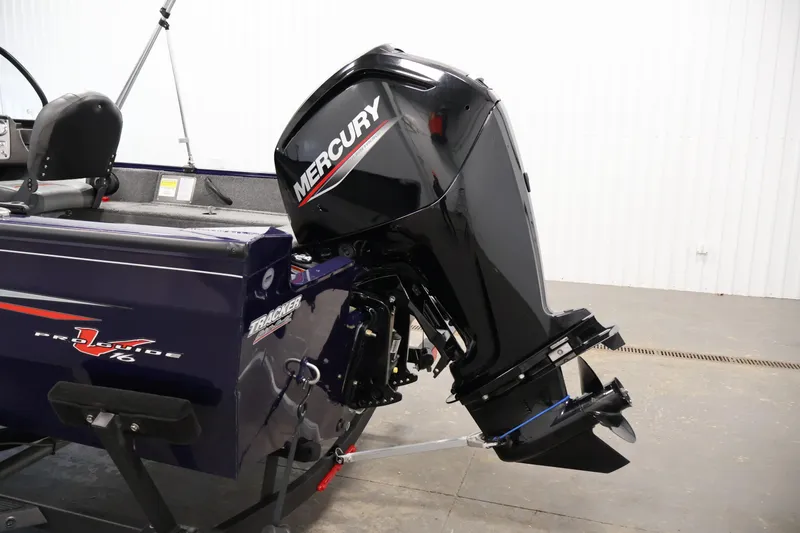Slide: The Image of 2024 Tracker Pro Guide V-16 WT boat with Mercury outboard motor in a showroom. - 36