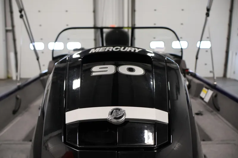 Slide: The Image of 2024 Tracker Pro Guide V-16 WT with Mercury 90 engine in a garage setting. - 38