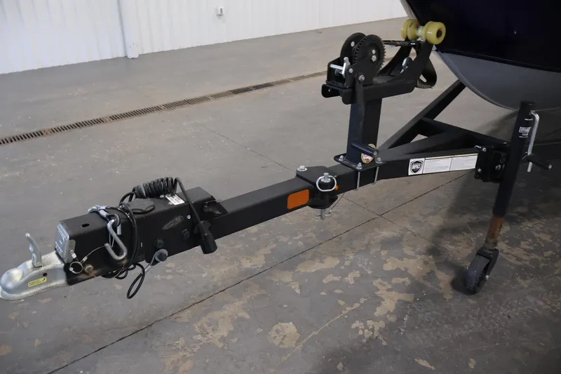 Slide: The Image of 2024 Tracker Pro Guide V-16 WT trailer hitch in a garage setting. - 40