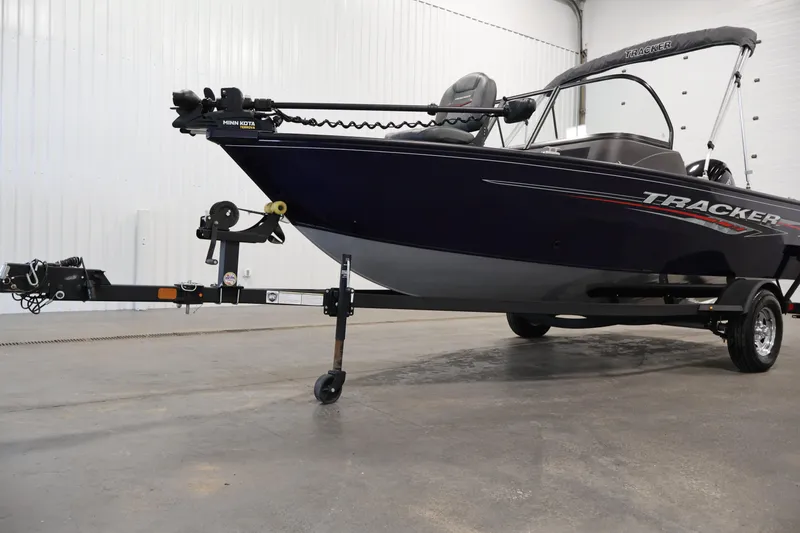 Slide: The Image of 2024 Tracker Pro Guide V-16 WT boat on trailer in indoor setting. - 41