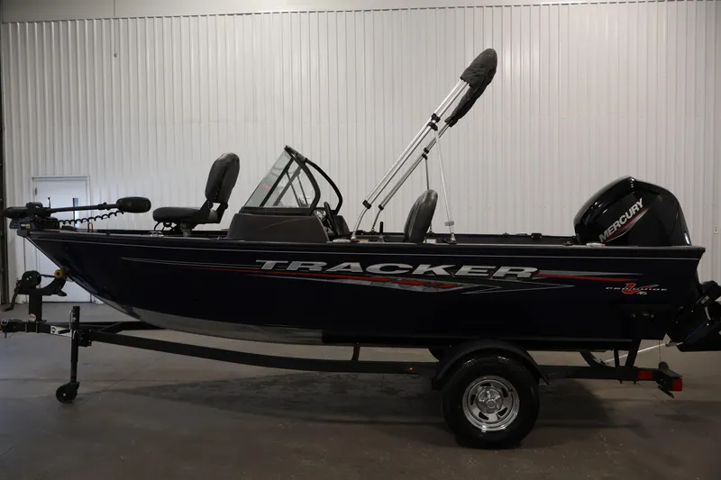 Slide: The Image of 2024 Tracker Pro Guide V-16 WT boat with Mercury engine in showroom. - 8
