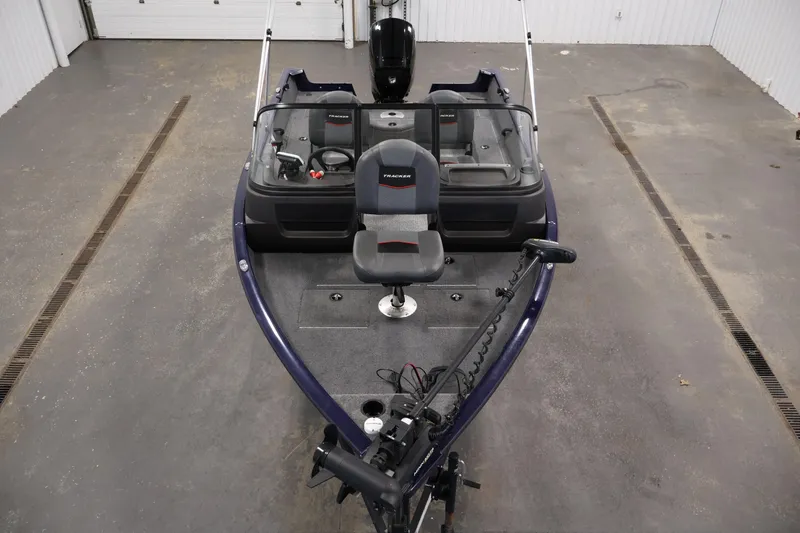 Slide: The Image of 2024 Tracker Pro Guide V-16 WT fishing boat in a garage setting. - 9
