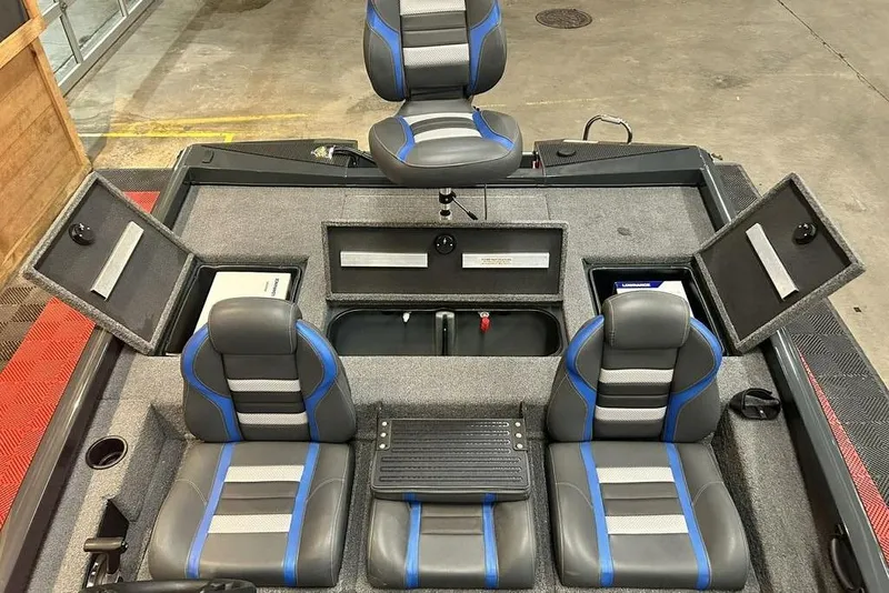 Slide: The Image of 2024 Ranger RT188P boat interior with gray and blue seats, storage compartments open. - 10