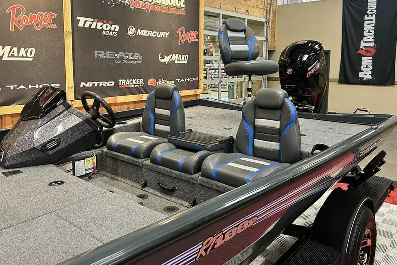 Slide: The Image of 2024 Ranger RT188P fishing boat interior with gray and blue seating, steering console, and motor. - 11