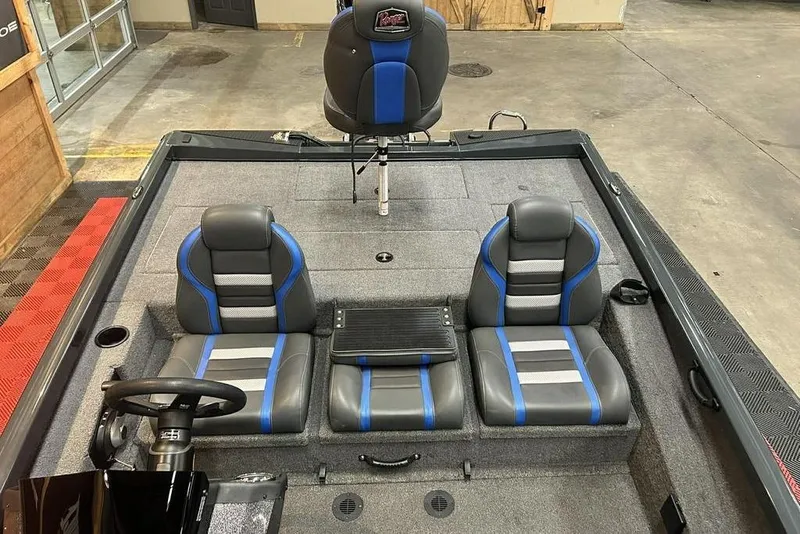 Slide: The Image of 2024 Ranger RT188P boat interior with gray and blue seating, steering wheel, and carpeted flooring. - 6