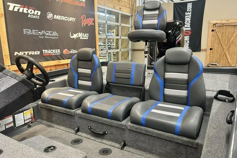 Slide: The Image of 2024 Ranger RT188P boat interior with gray and blue seating, steering wheel, and branded backdrop. - 8