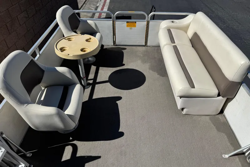 Slide: The Image of 1999 Godfrey Parti Kraft 240 ES boat interior with seating and table. - 11