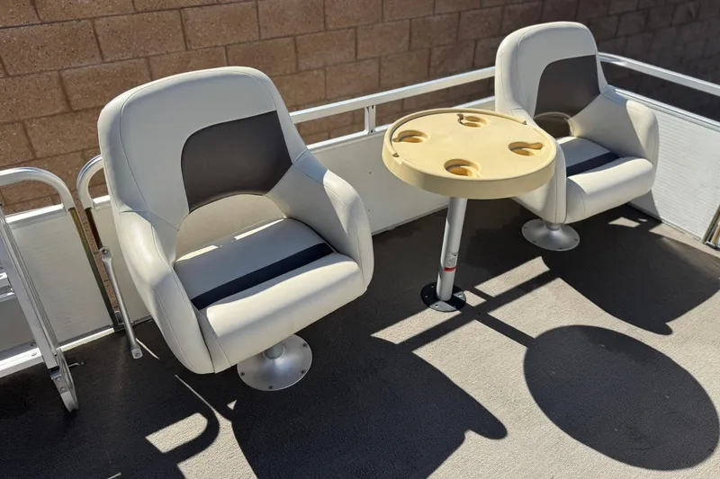 Slide: The Image of 1999 Godfrey Parti Kraft 240 ES boat seats with a round table in sunlight. - 12