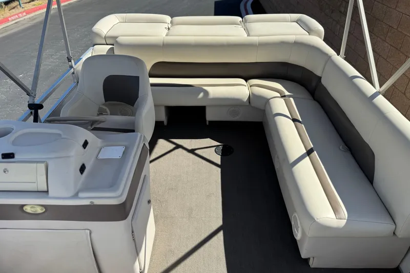 Slide: The Image of 1999 Godfrey Parti Kraft 240 ES pontoon boat interior with beige seating and helm. - 17