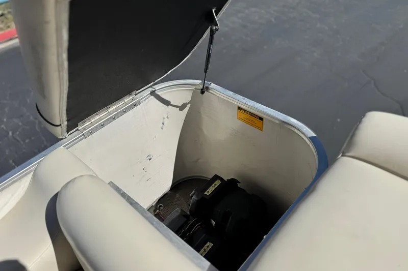 Slide: The Image of Open storage compartment in 1999 Godfrey Parti Kraft 240 ES boat, showing interior details. - 19