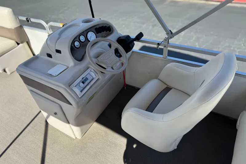 Slide: The Image of 1999 Godfrey Parti Kraft 240 ES boat helm with steering wheel and gauges. - 20
