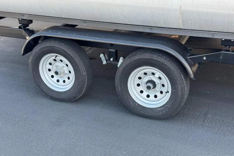 Slide: The Image of Trailer wheels of a 1999 Godfrey Parti Kraft 240 ES on asphalt surface. - 23