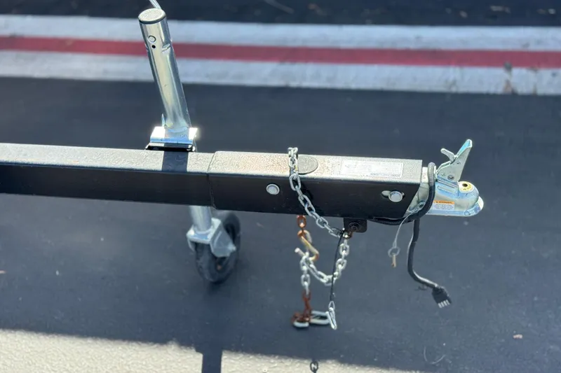 Slide: The Image of Trailer hitch with chains and wheel, Godfrey Parti Kraft 240 ES, 1999 model. - 24
