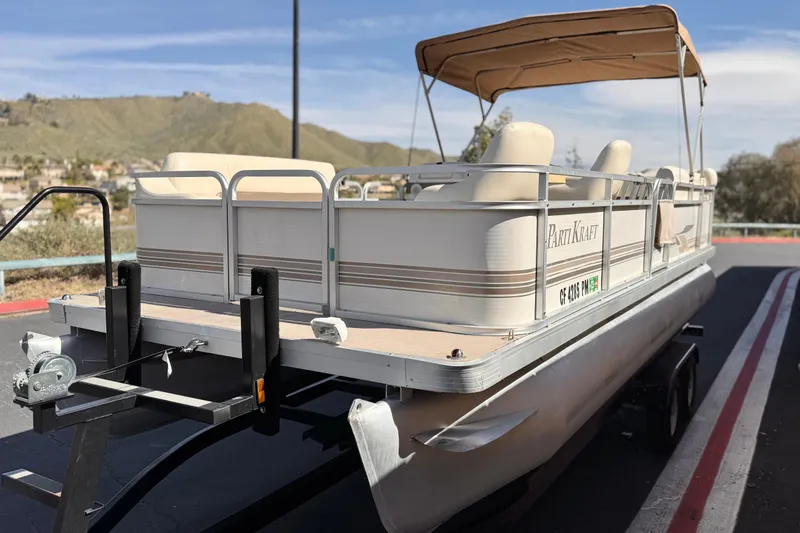 Slide: The Image of 1999 Godfrey Parti Kraft 240 ES pontoon boat on trailer, scenic background. - 3