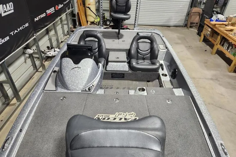Slide: The Image of 2019 Falcon F195 boat interior with seating and storage compartments in a garage setting. - 14