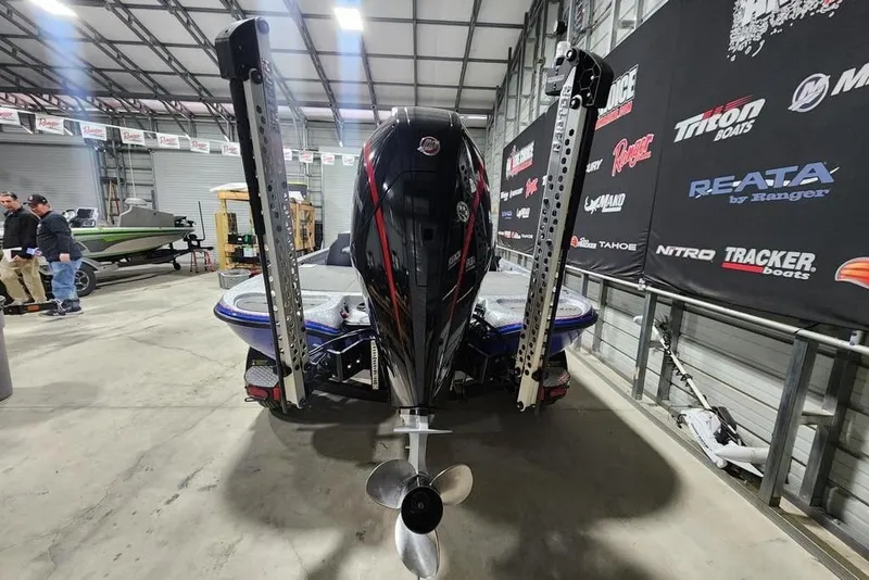 Slide: The Image of 2019 Falcon F195 boat in showroom with powerful outboard motor. - 5