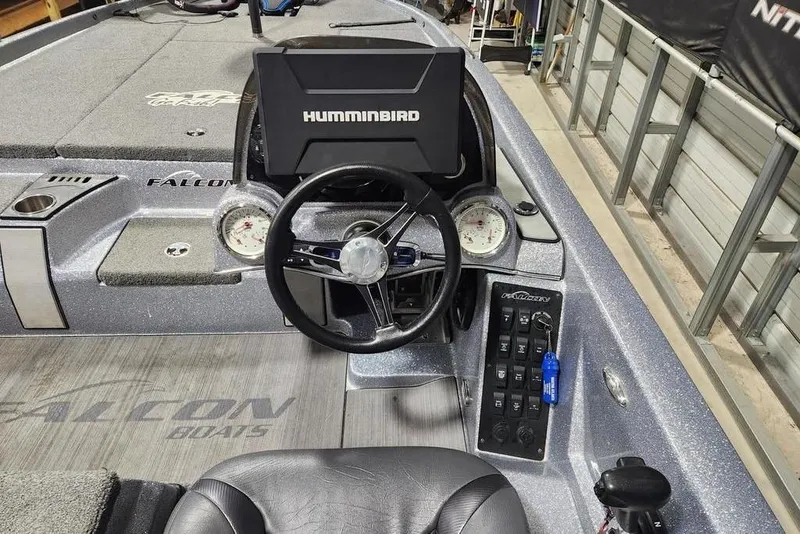 Slide: The Image of 2019 Falcon F195 boat dashboard with steering wheel and Humminbird display. - 6