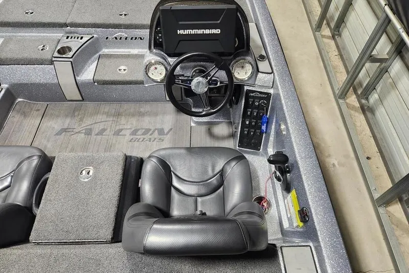 Slide: The Image of Interior of a 2019 Falcon F195 boat with steering console and seating. - 8