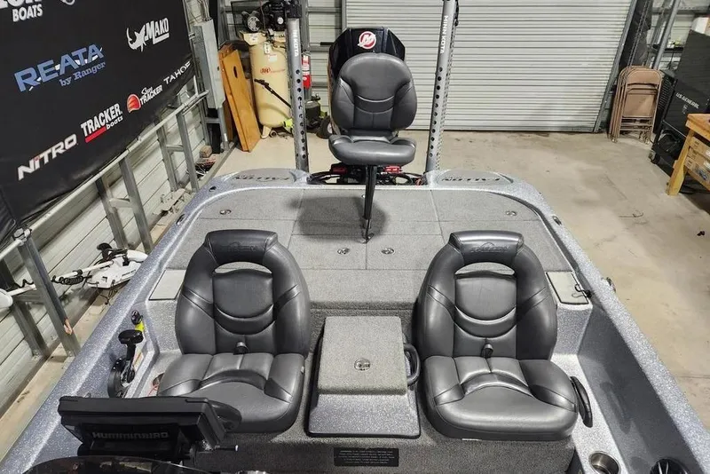 Slide: The Image of 2019 Falcon F195 boat interior with three black seats in a garage setting. - 9