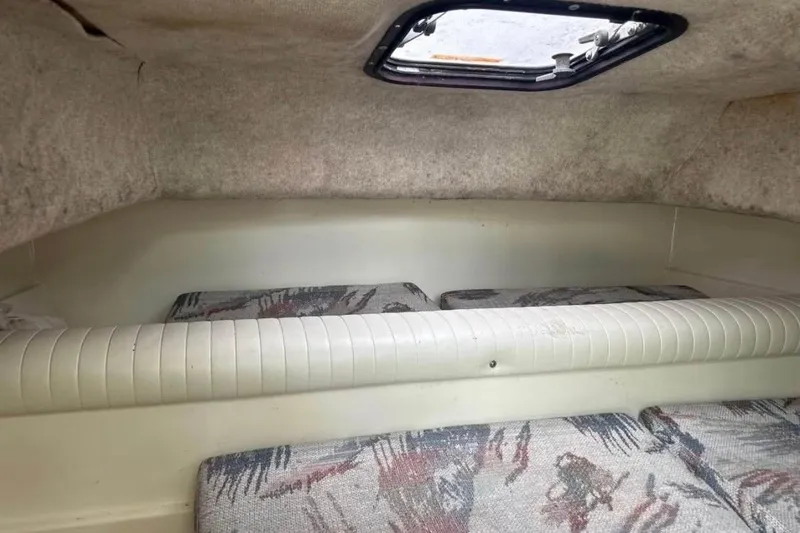 Slide: The Image of Interior cabin of a 1997 Sea Cat SL5C boat with patterned cushions and a small window. - 10