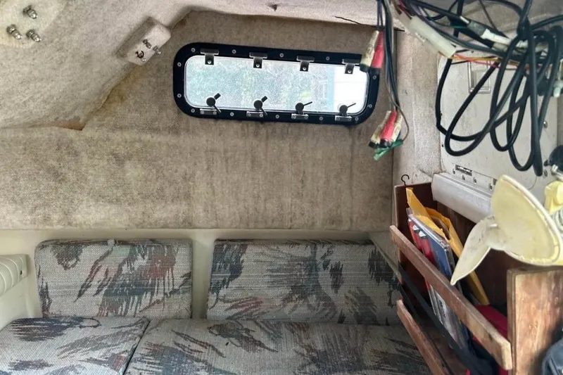Slide: The Image of Interior of a 1997 Sea Cat SL5C boat with seating and storage compartments. - 13
