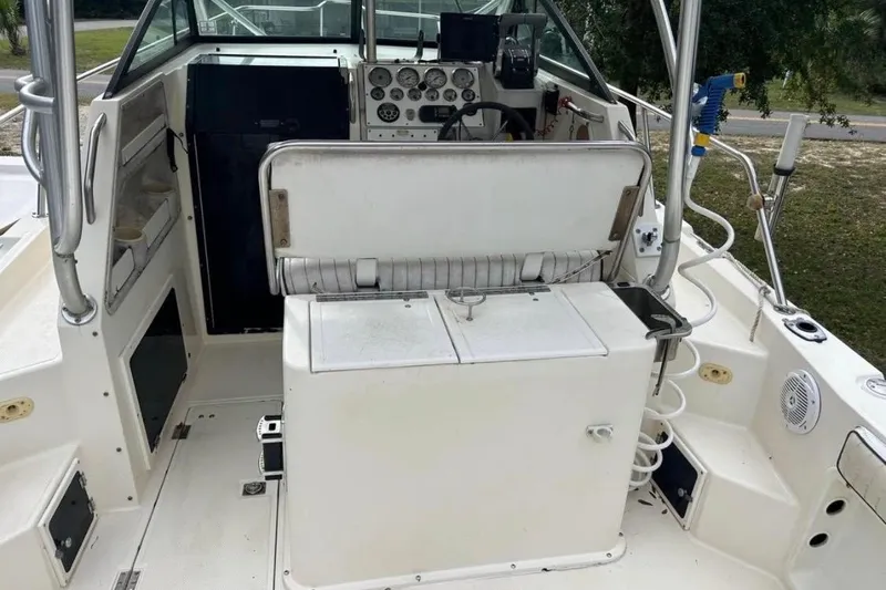 Slide: The Image of 1997 Sea Cat SL5C boat cockpit with steering wheel, gauges, and seating area. - 7