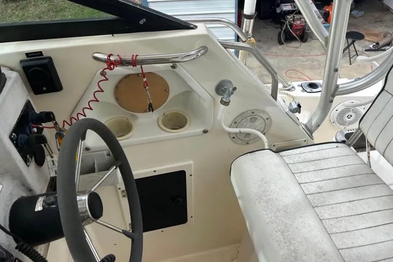 Slide: The Image of 1997 Sea Cat SL5C boat cockpit with steering wheel and control panel. - 8
