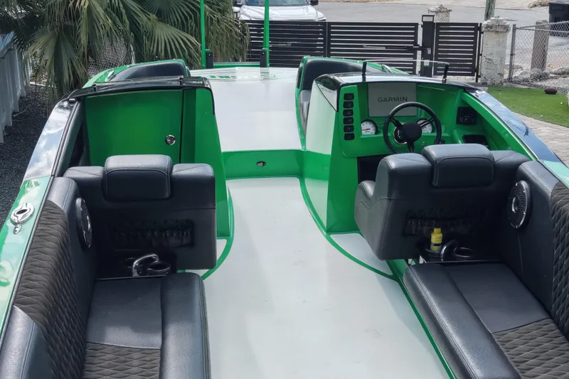 Slide: The Image of 2021 E-Ticket 29 boat interior with green accents and Garmin navigation system. - 14