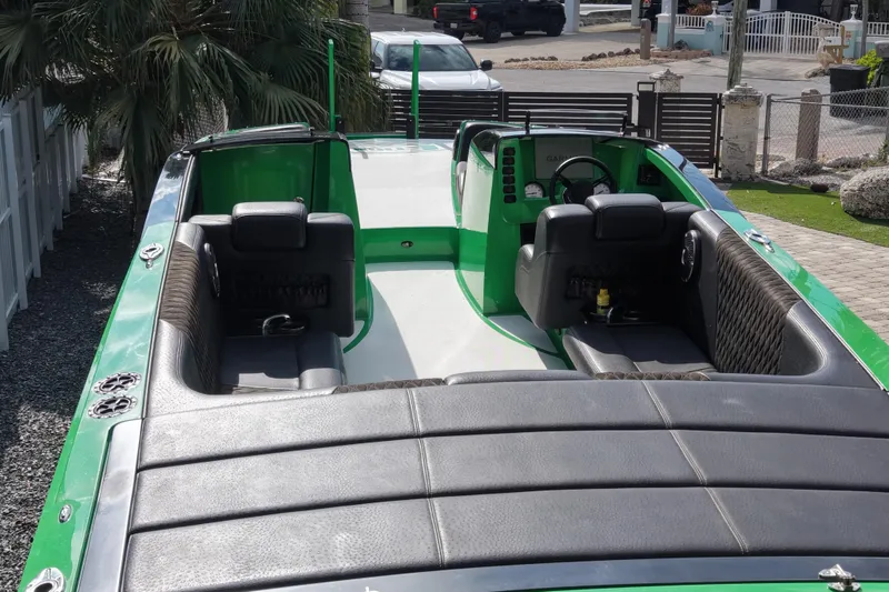 Slide: The Image of 2021 E-Ticket 29 boat with green and black interior, parked outdoors. - 15