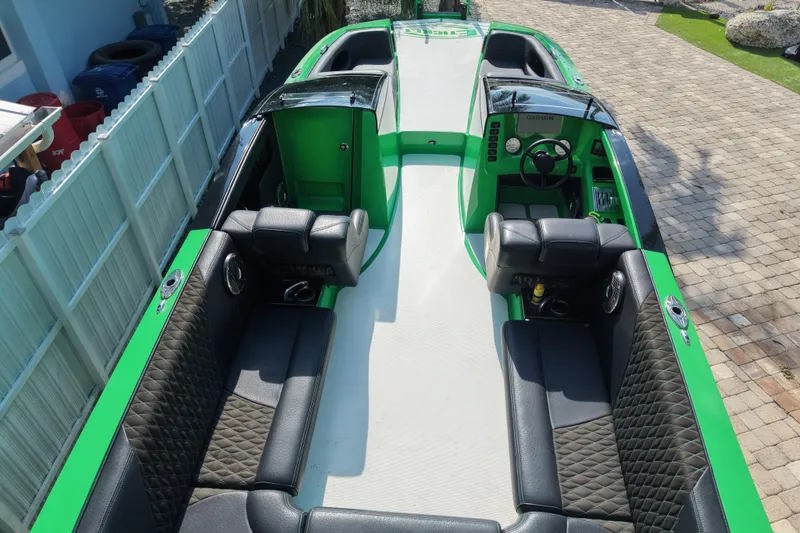 Slide: The Image of 2021 E-Ticket 29 boat with green and black interior, featuring spacious seating and modern controls. - 18