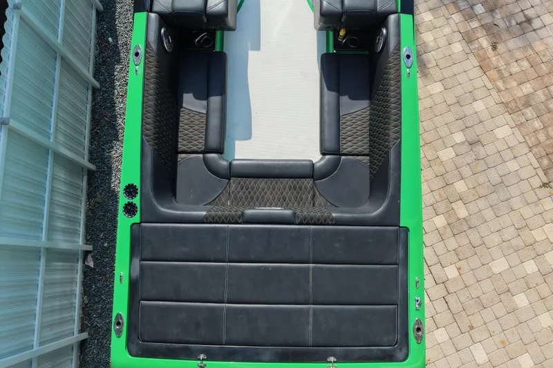Slide: The Image of Top view of 2021 E-Ticket 29 boat with black seating and green accents. - 19