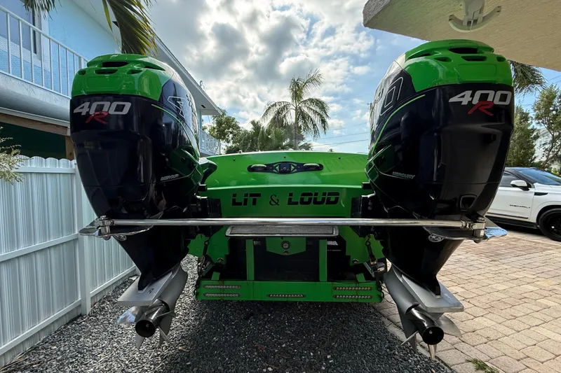 Slide: The Image of Green 2021 E-Ticket 29 boat with dual 400R engines, parked outdoors. - 23