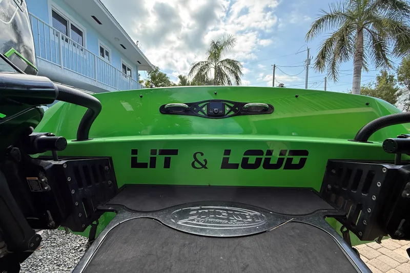 Slide: The Image of Green 2021 E-Ticket 29 boat with "Lit & Loud" text, palm trees in background. - 24