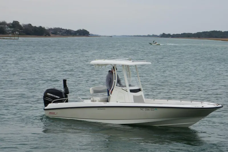Slide: The Image of 2016 Boston Whaler 240 Dauntless boat cruising on a calm waterway. - 11