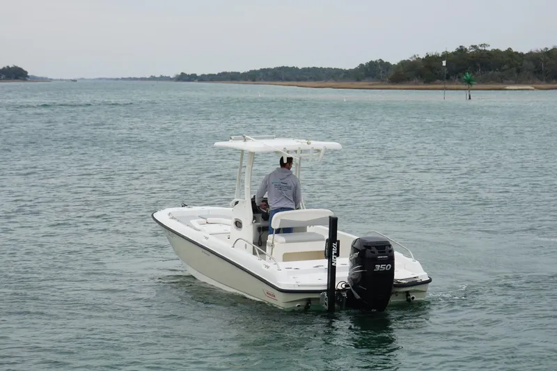 Slide: The Image of 2016 Boston Whaler 240 Dauntless boat cruising on calm waters. - 13